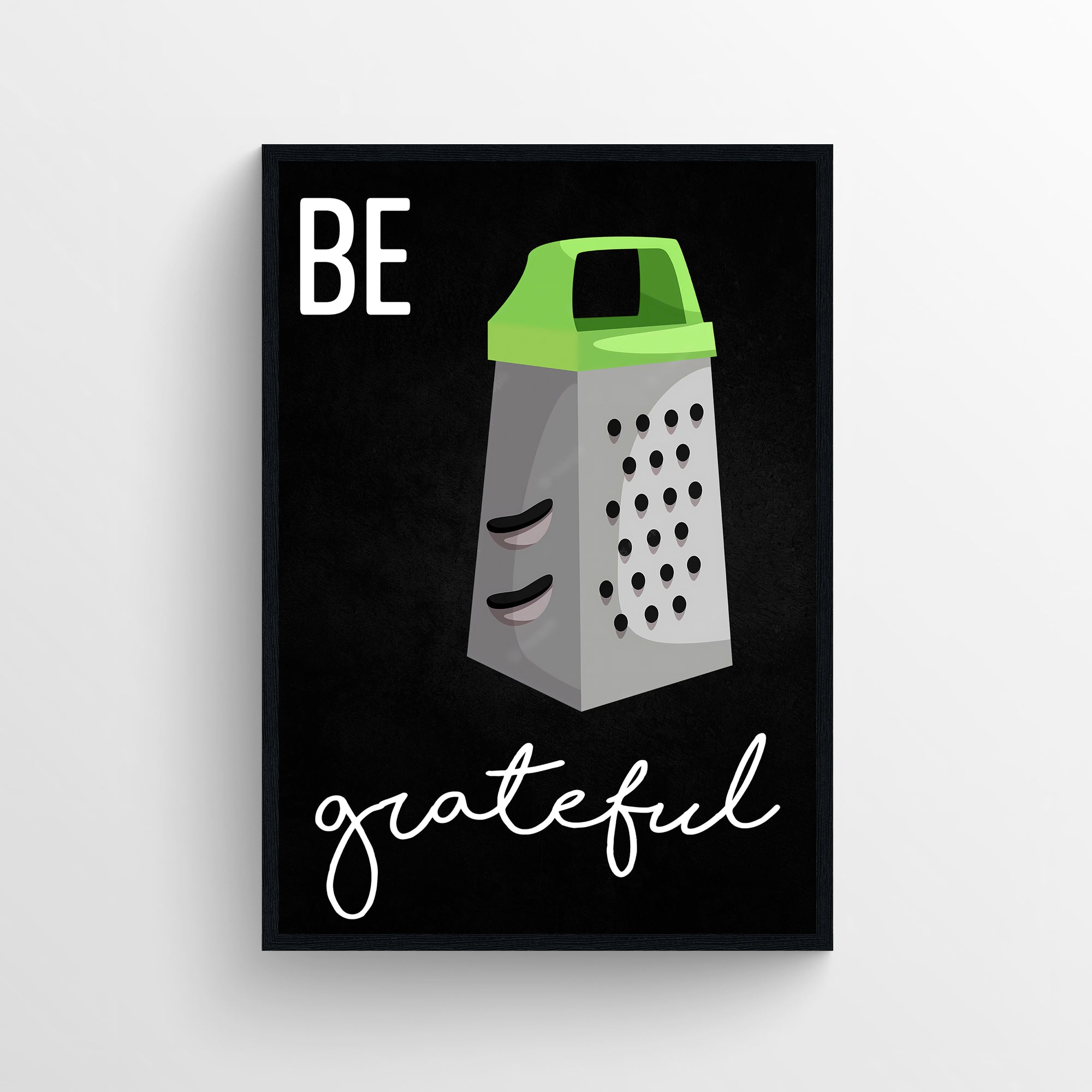 Funny kitchen wall art with “Be Grateful” pun and cartoon cheese grater illustration on a black background — witty food decor by CollegeWares.