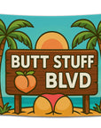 Cartoon-style beach flag with a wooden sign reading “Butt Stuff Blvd,” palm trees, a peach emoji, and sunset — funny tropical party flag for dorms and beach houses from CollegeWares.