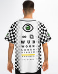Black-and-white checkerboard rave jersey on a man facing away. The back features the cyclops eye, infinity symbol, stacked eye-chart text reading WUB, WOOK, LASER, RIDDIM, and a yellow-highlighted CYCLOPS line. Checkerboard gradient panels run down both sides with matching eye patches on the sleeves.