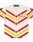 Flat front product shot of the white baseball jersey with downward-pointing red and yellow IN-N-OUT-style stripes, white piping, and a parody Drum-N-Bass arrow logo on the left chest.
