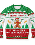 Funny Christmas sweater with green, red, and white design, gingerbread man, and “I’m Into Fitness—Fitness Cookie in My Mouth” quote — festive humor by CollegeWares.