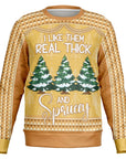 Yellow and orange Christmas sweater with “I Like Them Real Thick and Sprucey” slogan and snow-covered tree graphic — playful and punny design from CollegeWares.