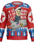 Red and blue sweater featuring cartoon Kim Jong Un on a missile with “Let It Blow” text — bold, edgy humor from CollegeWares.
