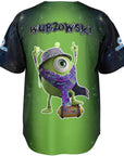 Ghost mockup showing the green gradient back with the one-eyed creature in rave accessories standing on a small speaker and the “WUBZOWSKI” wordmark above the character.