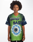 Woman wearing a green-centered jersey with dark galaxy sleeves and a large blue-white electrified eyeball printed in the middle, with the text “SCARE BASS” above it.