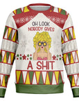 White and red Christmas sweater with “Oh Look Nobody Gives a Shit” slogan, cartoon blonde woman with binoculars — bold and funny anti-holiday energy from CollegeWares.