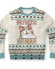Beige and teal Christmas sweater with smug cat face and “Pathetic Human” text — passive-aggressive pet humor from CollegeWares.