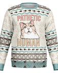 Beige and teal Christmas sweater with smug cat face and “Pathetic Human” text — passive-aggressive pet humor from CollegeWares.