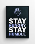Poster design with the quote “Stay Hungry. Stay Humble.” where “Hungry” and “Humble” are highlighted in soft purple to create a secret double-meaning: drive and humility in contrast. Centered text is set against a black background with a rich uncle cartoon character at the top — a perfect daily reminder for dreamers, hustlers, and grinders.