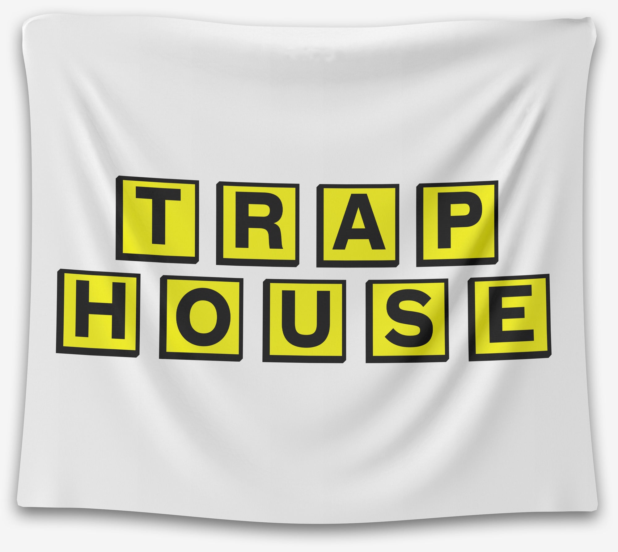 White tapestry with bold yellow-black block letters spelling “TRAP HOUSE” in a stacked design — edgy dorm quote tapestry from CollegeWares.