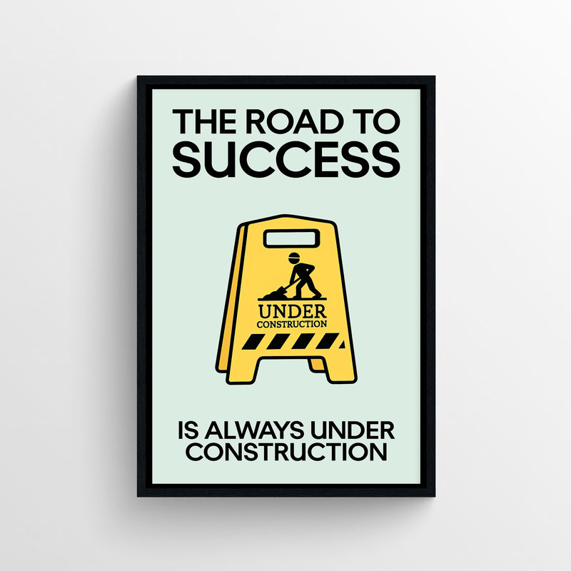 Motivational poster with bold text reading “The Road to Success Is Always Under Construction” and a yellow construction sign graphic — modern aesthetic wall decor for dorms, study spaces, and offices by CollegeWares.