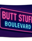 Neon pink and blue flag reading “Butt Stuff Boulevard” — glowing bar sign-style design perfect for party rooms, dorms, and nightlife lovers from CollegeWares.