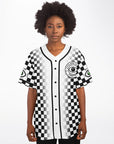 Front view of a black-and-white checkerboard rave jersey worn by a woman. The front displays the Cyclops Vision Center crest on the left chest with clean black piping and a full checkerboard fade. Green-eye sleeve patches visible.