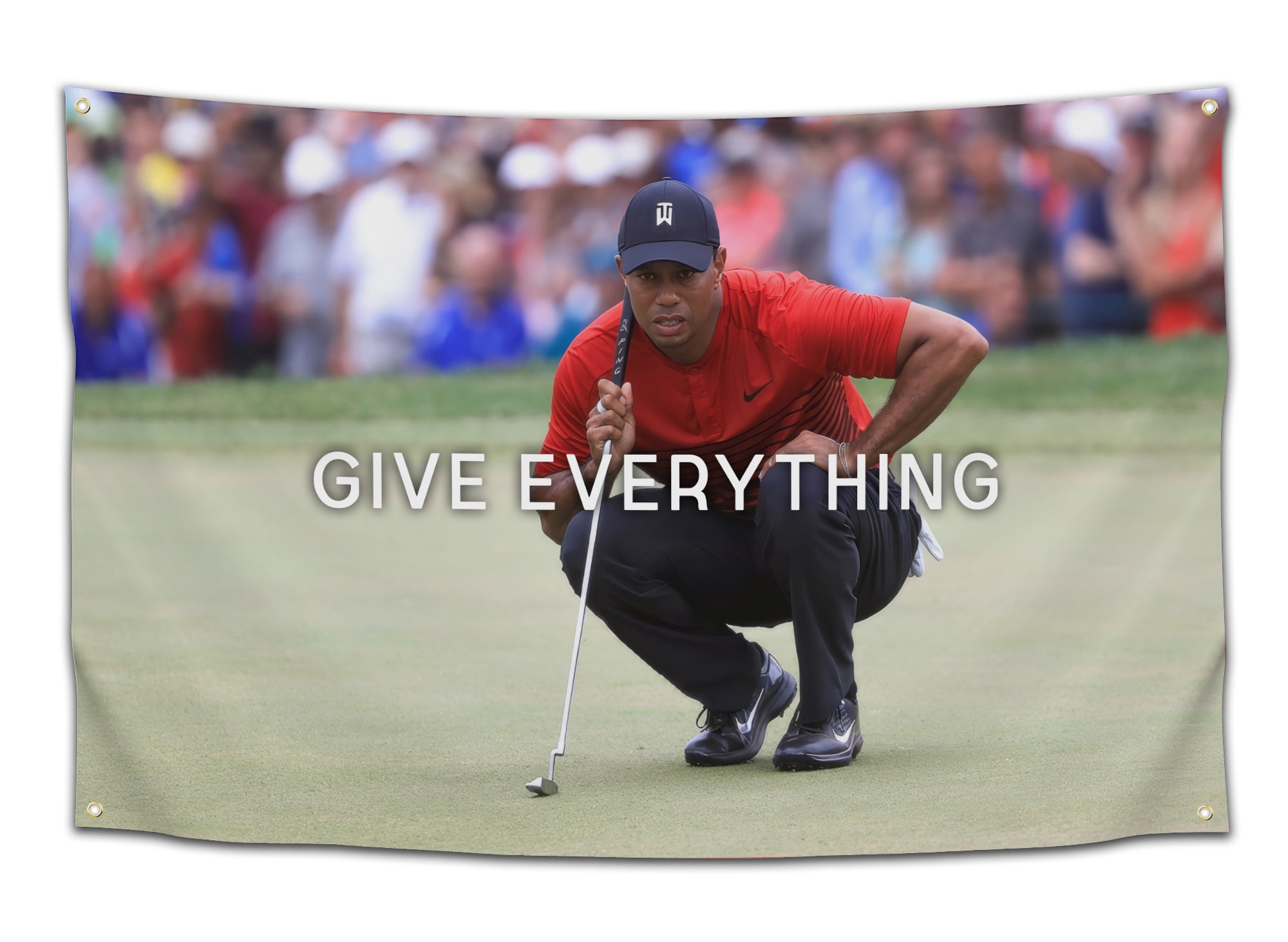 Iconic moment flag featuring Tiger Woods crouched on the putting green in his signature focused stance with the phrase “Give Everything” displayed across the image. This famous sports photo decor serves as cultural icon wall art and statement wall flag for dorm rooms, offices, apartments, and golf enthusiasts from CollegeWares.