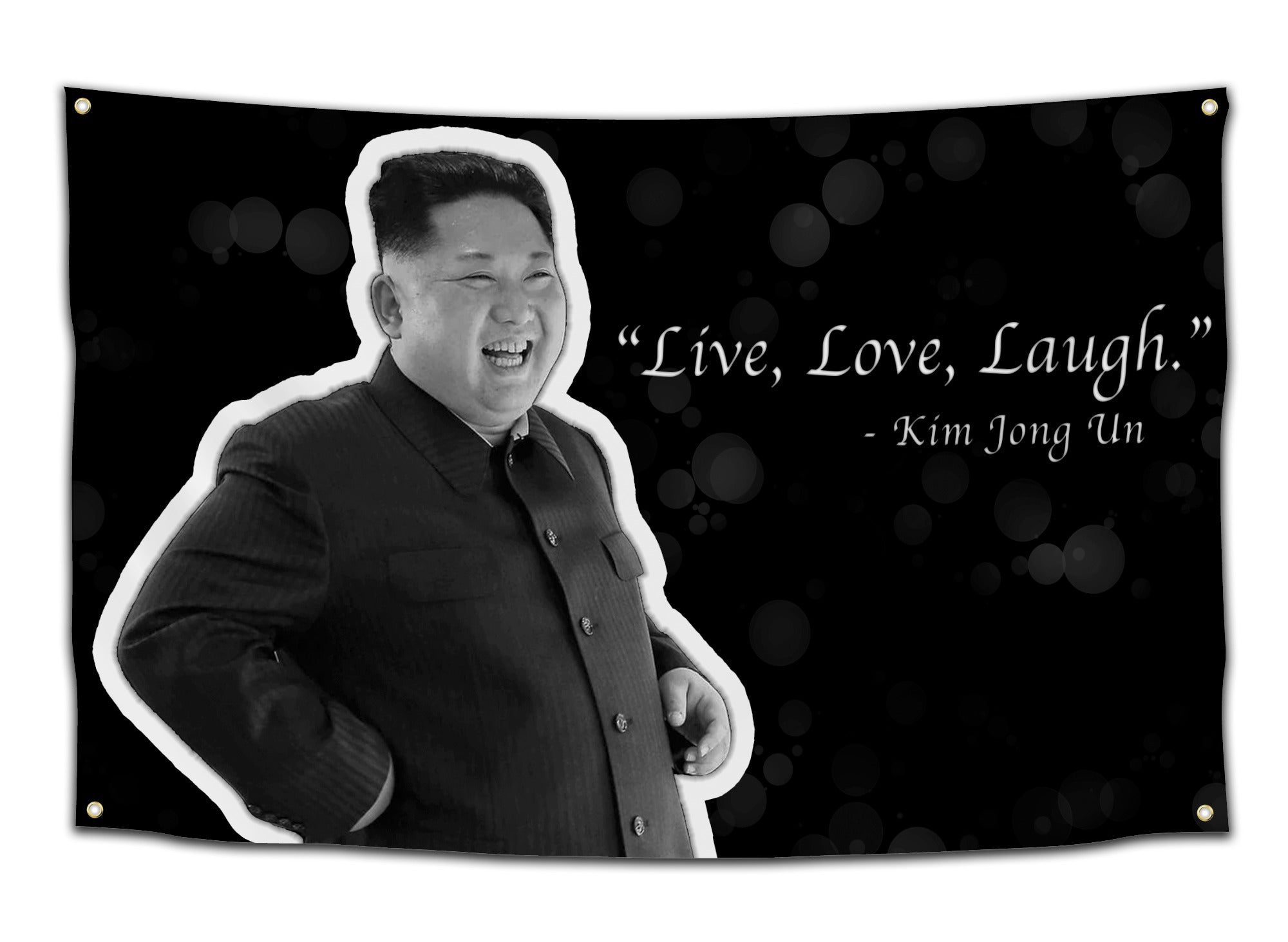 Black flag with a grayscale photo of Kim Jong Un laughing and white text “Live, Love, Laugh” — dark humor meme flag from CollegeWares.