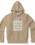Hoodie with the phrase “REMEMBER ME IN YOUR PRAYERS LIKE YOU DO IN YOUR GOSSIP” in bold white bubble text, centered on a light brown hoodie with white drawstrings — sassy spiritual energy for the outspoken soul.