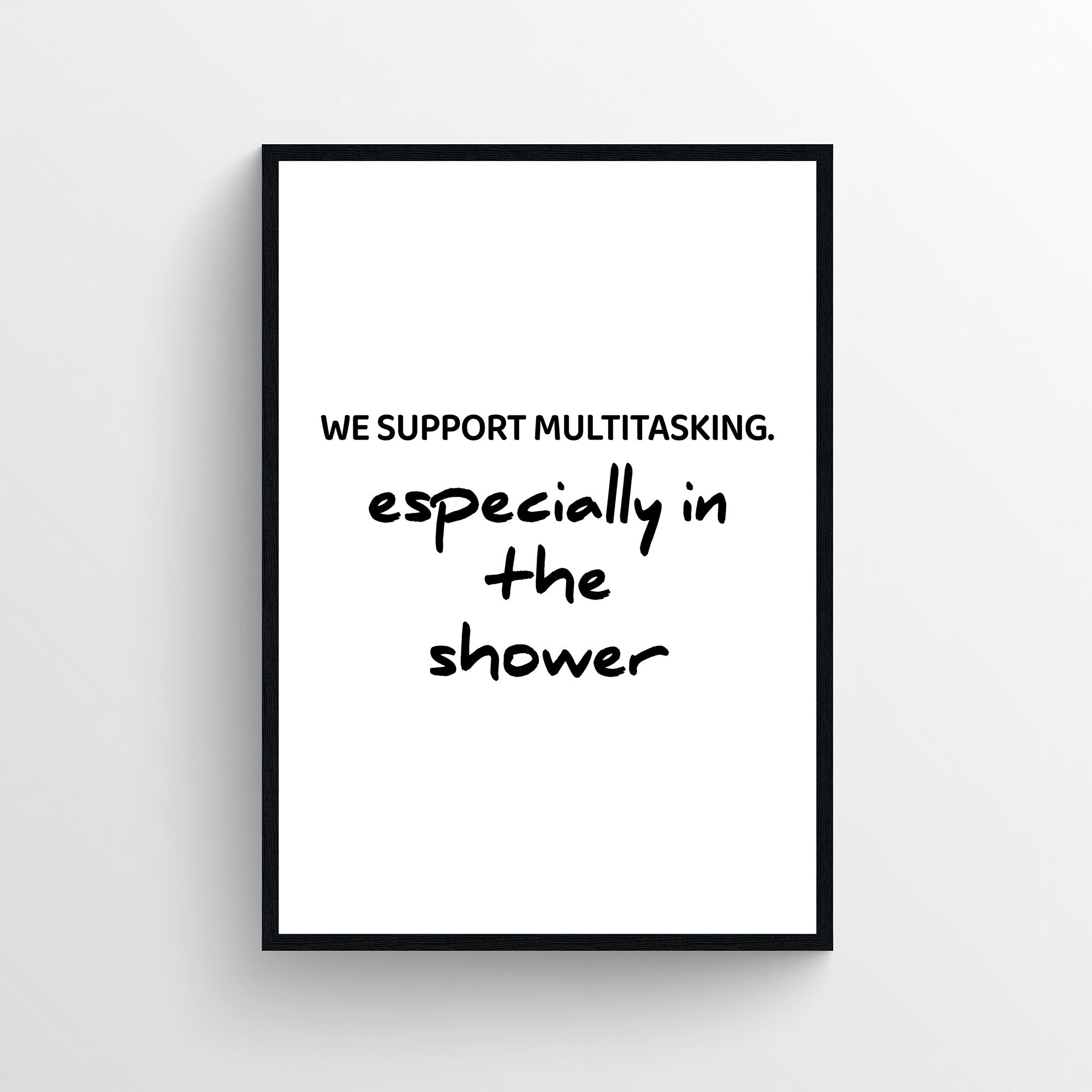 Minimalist funny bathroom poster with the text “We Support Multitasking. especially in the shower” in bold and handwritten typography. Humorous bathroom wall art designed for bathrooms and guest bathrooms from CollegeWares.