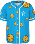 3D mockup of Yookie Crisp baseball jersey front, bright blue with scattered cartoon chocolate-chip cookies and a white Yookie logo on the chest.