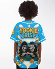 Female model wearing Yookie Crisp baseball jersey back view, featuring playful Yookie Crisp logo, DJ wolf duo, cookie graphics, and creamy milk splash.