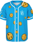 3D mockup of Yookie Crisp baseball jersey front, bright blue with scattered cartoon chocolate-chip cookies and a white Yookie logo on the chest.
