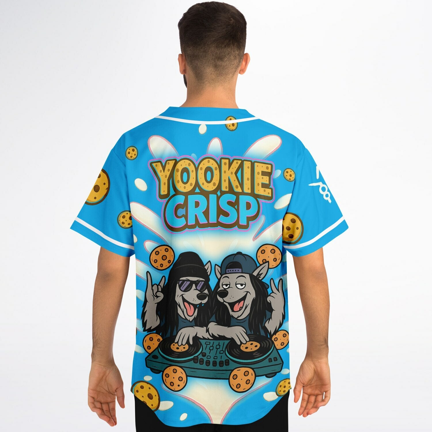 Male model wearing Yookie Crisp baseball jersey back view, showcasing bold logo, cartoon wolf DJs on cookie turntables, and flying cookies over a neon-blue base.