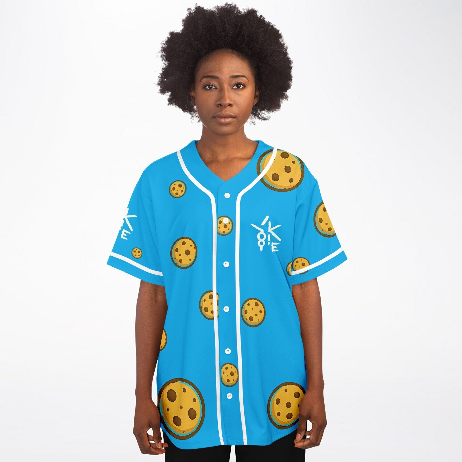 Female model wearing Yookie Crisp baseball jersey front view, cookie-print design on electric-blue fabric with white Yookie logo on the left chest.