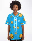 Female model wearing Yookie Crisp baseball jersey front view, cookie-print design on electric-blue fabric with white Yookie logo on the left chest.