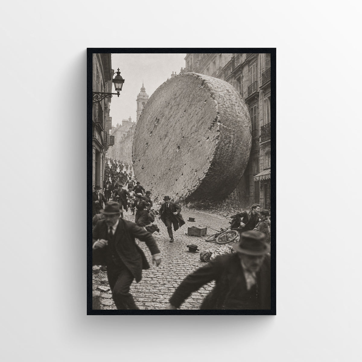 Black-and-white surreal poster showing a massive wheel of cheese rolling through a crowded historic city street as people scatter — vintage-style wall art from CollegeWares.