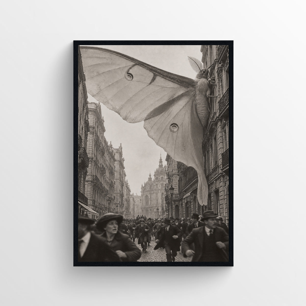 Black-and-white surreal poster showing a colossal moth spreading its wings between buildings above a crowded historic city street — vintage-style wall art from CollegeWares.